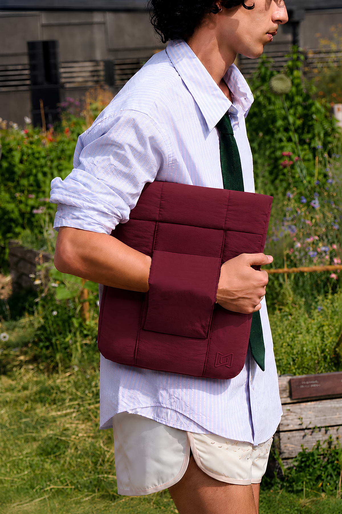 The Nest Laptop Sleeve in Burgundy carried by hand #Color_Burgundy