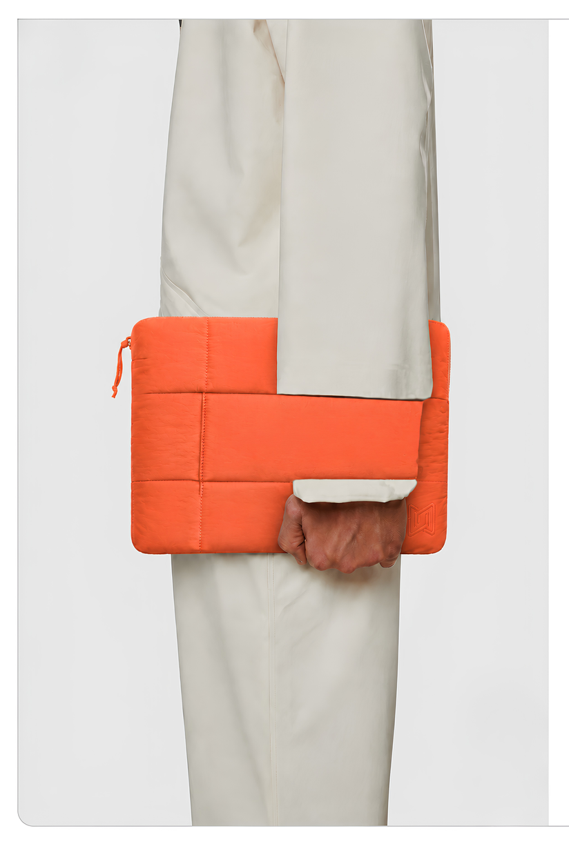 The Nest Laptop Sleeve in Rust Orange carried by hand #Color_Rust Orange
