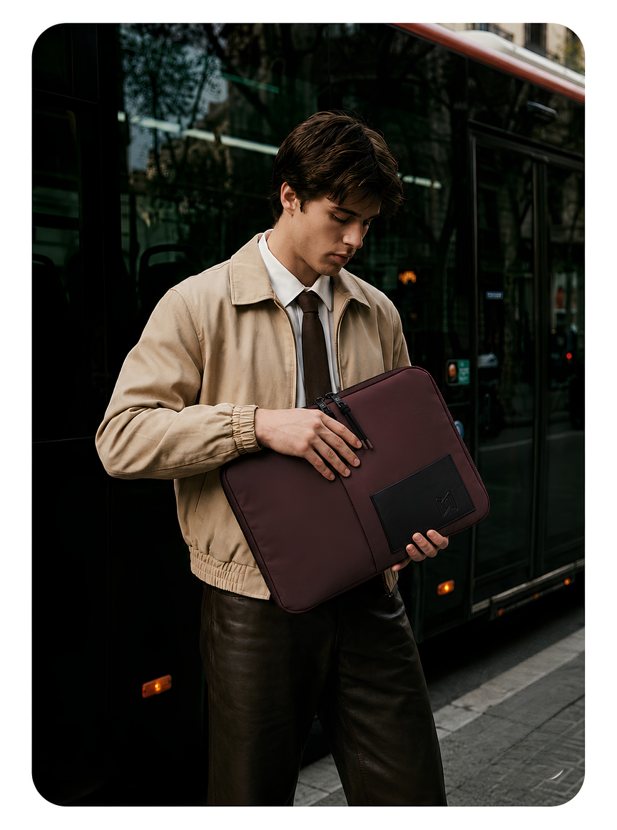 The Loft Laptop Sleeve in Chocolate carried in hand #Color_Chocolate