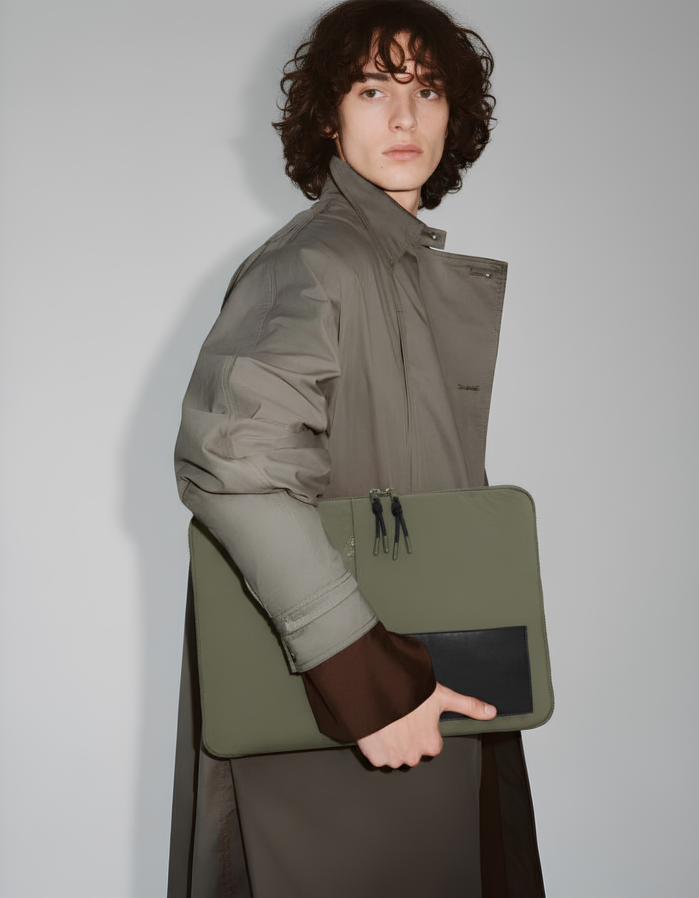 The Loft Laptop Sleeve in Green carried in hand #Color_Green
