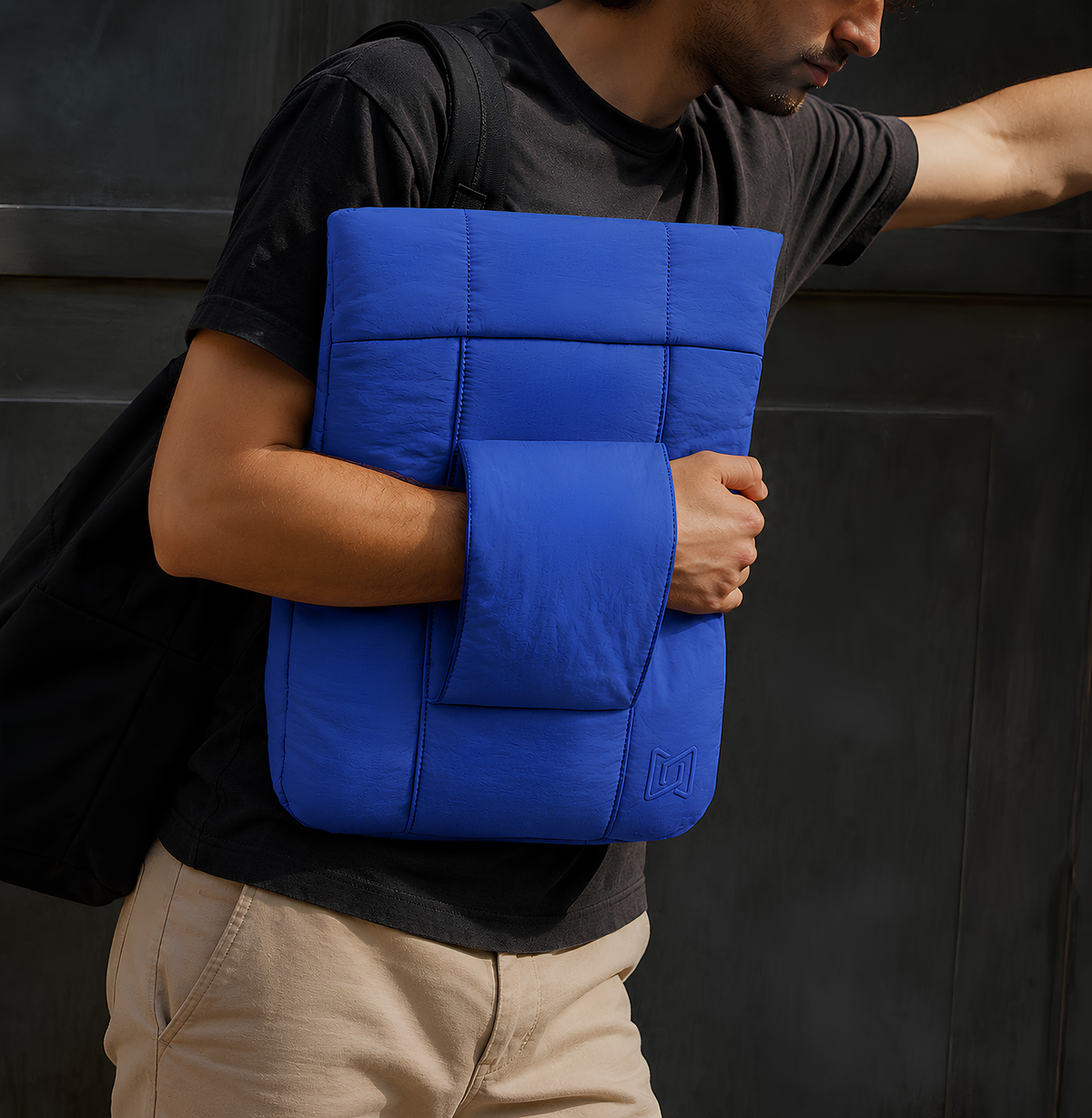 The Nest Laptop Sleeve in Blue carried by hand #Color_Blue