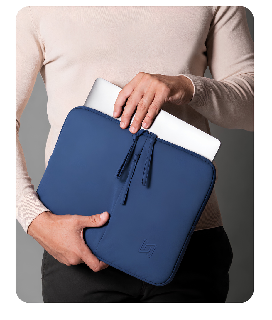 The Port Laptop Sleeve in Blue carried in hand #Color_Blue