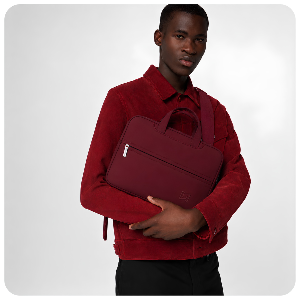 The Studio Portfolio in Burgundy carried in the arm #Color_Burgundy