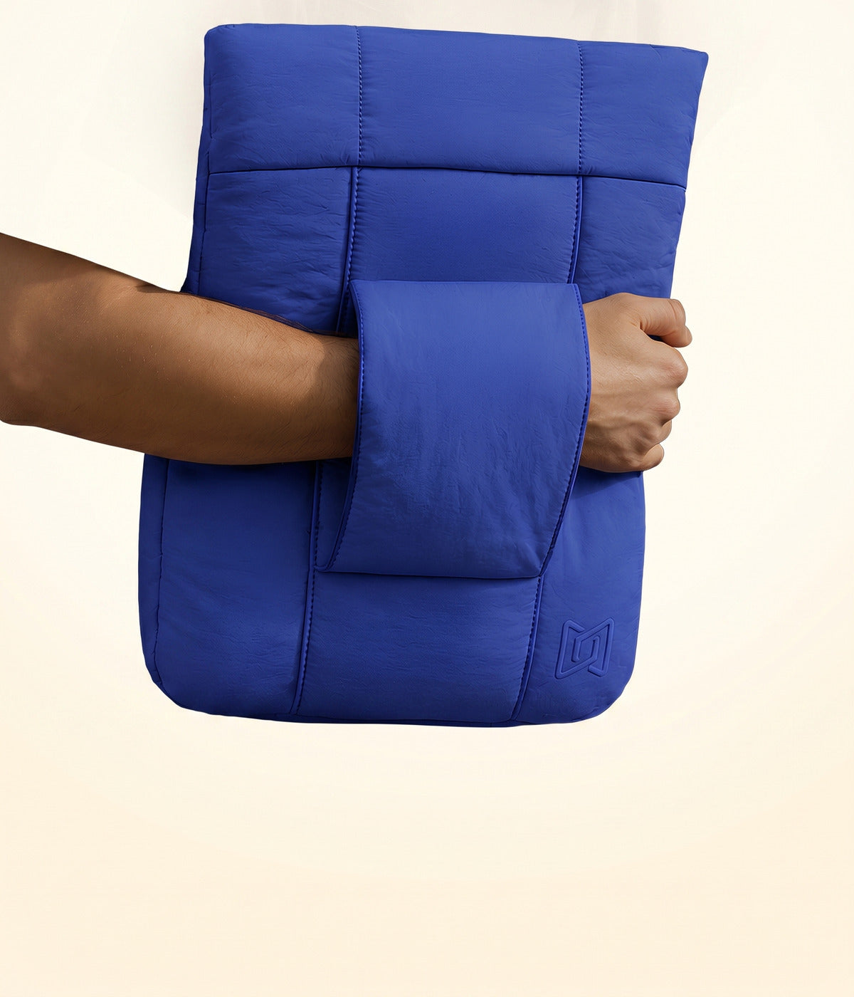 Muvtech padded laptop sleeve in cobalt blue, held under arm